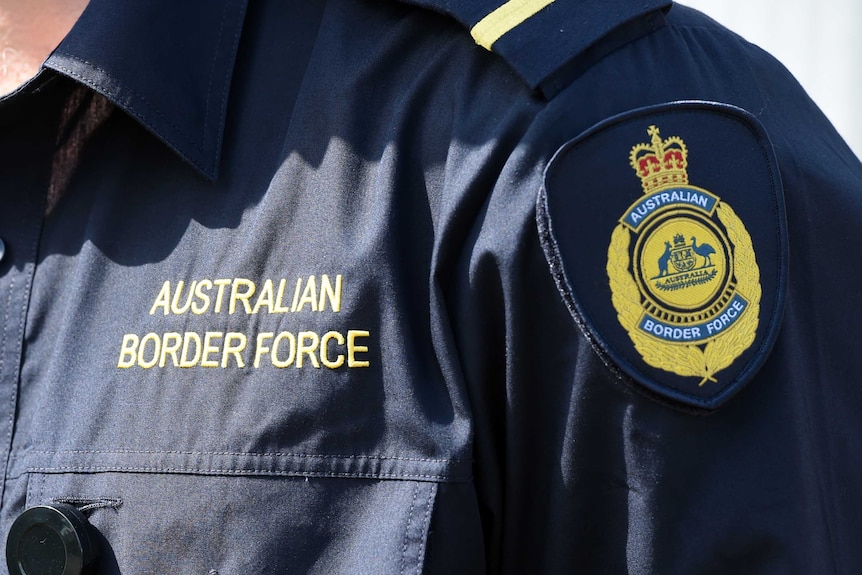 Australian Border Force logos are seen on the uniform of an officer in Brisbane, Thursday, Sept. 3, 2015.