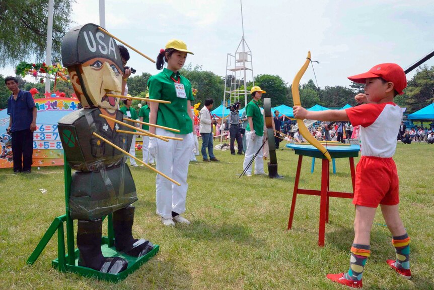 A child shoots an arrow at an effigy of a US soldier at an amusement park in Pyongyang.
