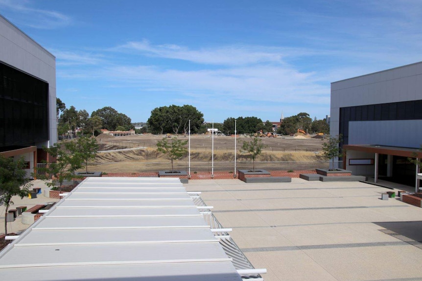 The old oval is visible from between two buildings.