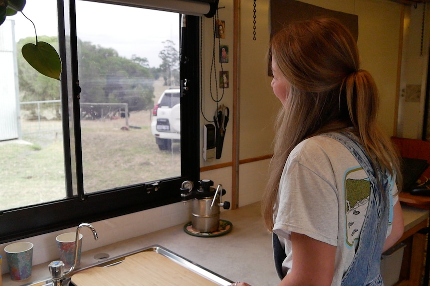 woman in van looking out window