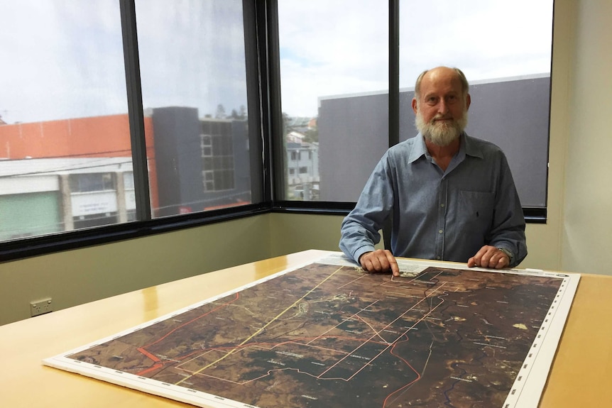 Chris Wallin with a map depicting land the company has a mining lease application on in the Bowen Basin