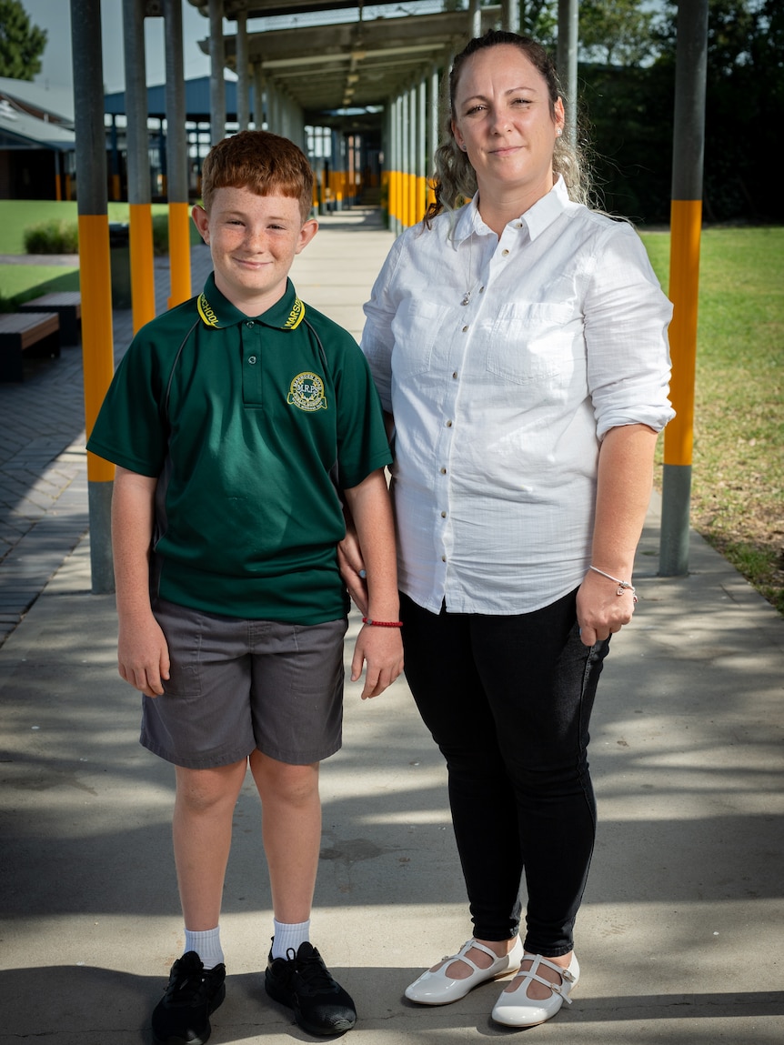 Jaclina Trpesk standing with her son Sashe Andonov on a footpath at school.