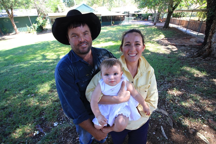 Glen Brooker, Lisa Walker and their daughter Freya in the foreground with Carlton Hill Station homestead in the background