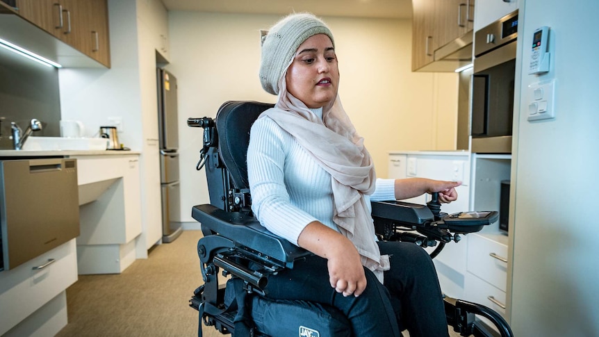 Fathema Anwar moves though her accessible kitchen in her wheelchair.