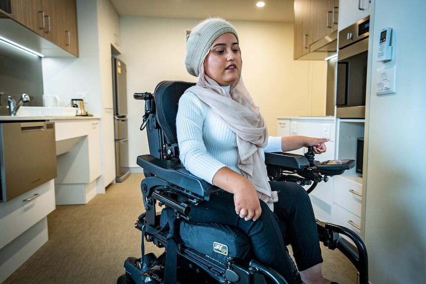 Fathema Anwar moves though her accessible kitchen in her wheelchair.