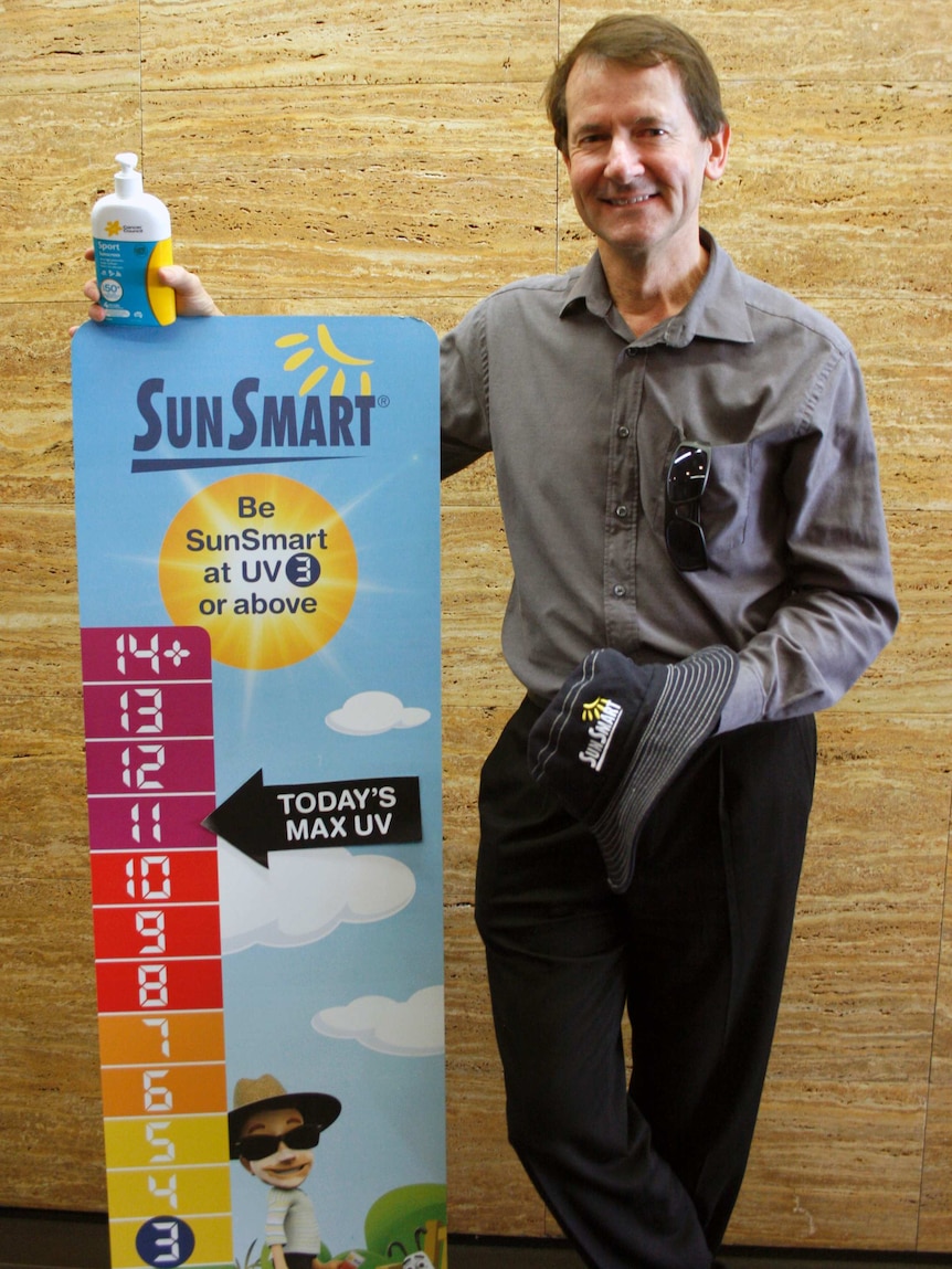 The Cancer Council's Mark Strickland stands beside a Sun Smart UV chart.