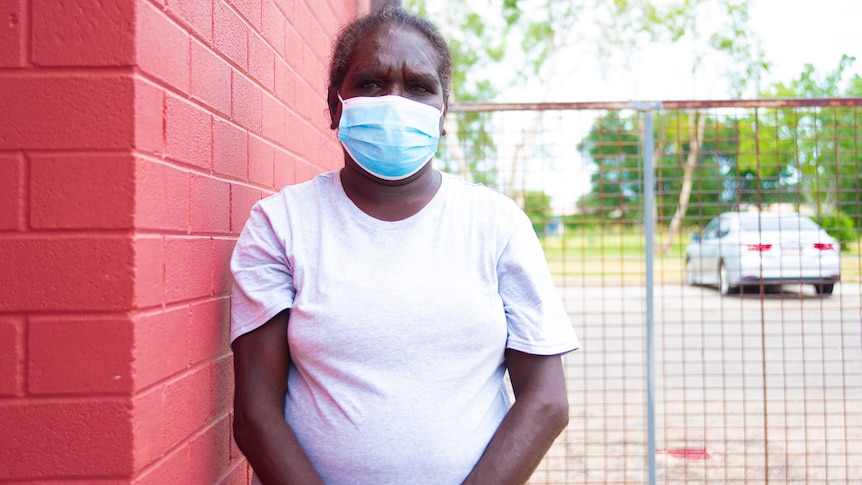 A woman wears a mask in Katherine.