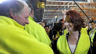 Julia Gillard greets staff at a Woolworths distribution centre at Warnervale (AAP)