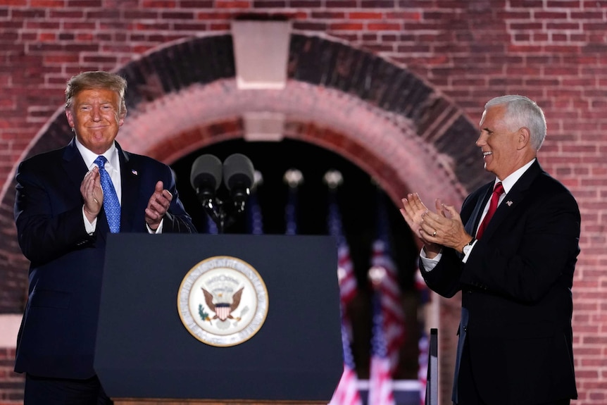 Donald Trump and Mike Pence clapping on a stage