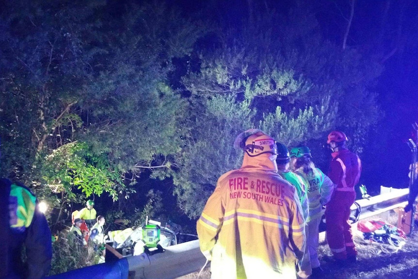 Emergency workers work to free woman from a car