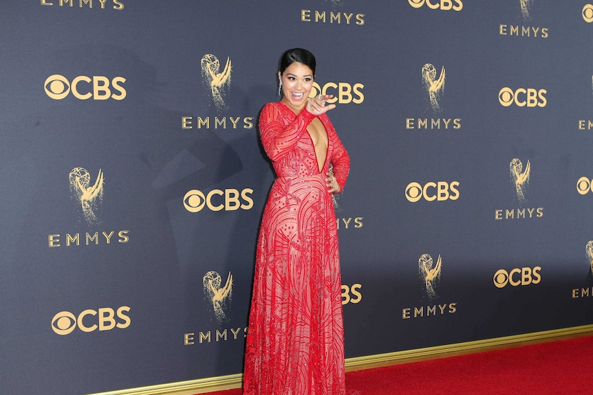Jane the Virgin star Gina Rodriguez wears a red lace low plunging gown.