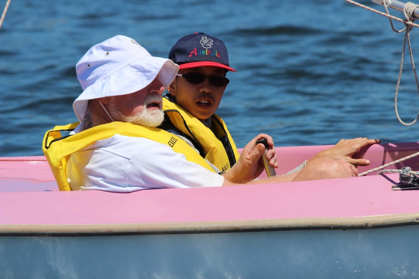 Mark Lim in sailing boat on Swan River