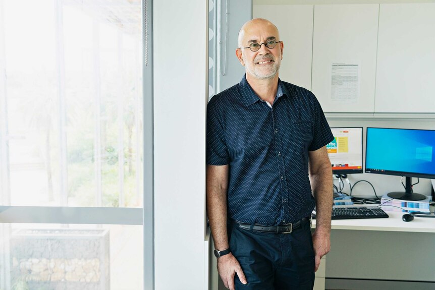Menzies School of Health research director Professor Alan Cass standing at his office door.