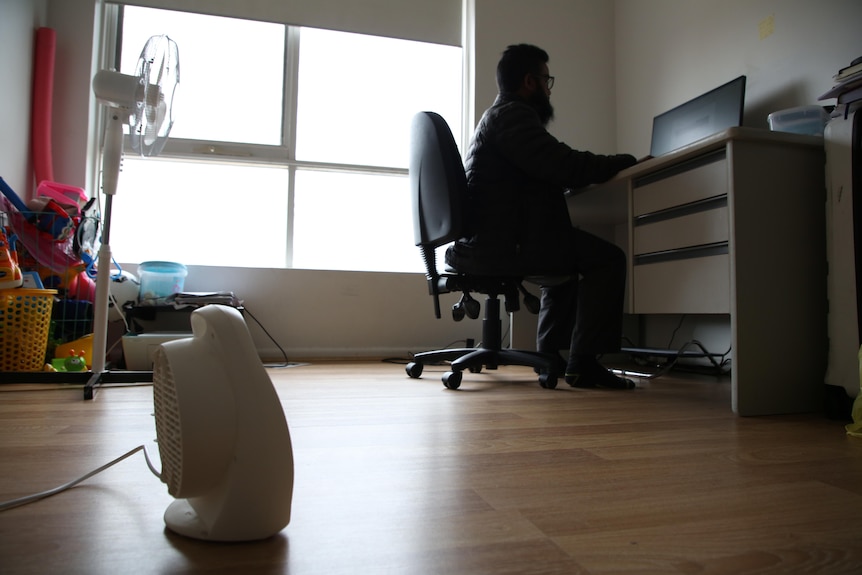 A man sitting at a desk.