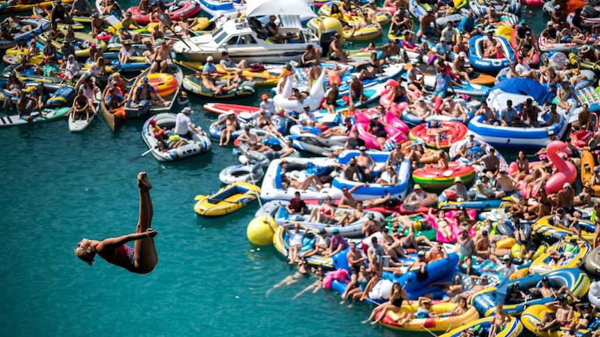 Crowds jockey for position on the water to watch Rhiannan Iffland at the Swiss stage of the Red Bull Cliff Diving championship.