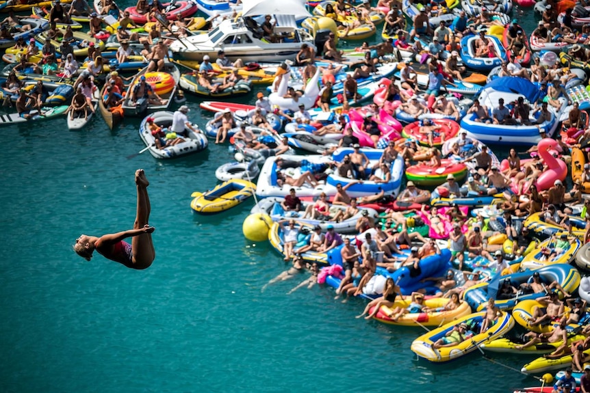 Crowds jockey for position on the water to watch Rhiannan Iffland at the Swiss stage of the Red Bull Cliff Diving championship.