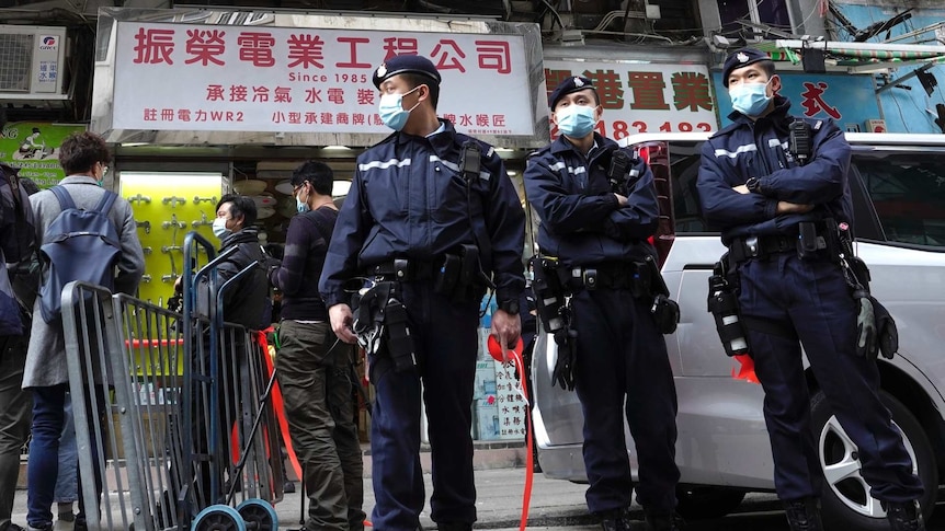 Police officers stand guard outside office of District councillor and lawyer Daniel Wong Kwok-tung