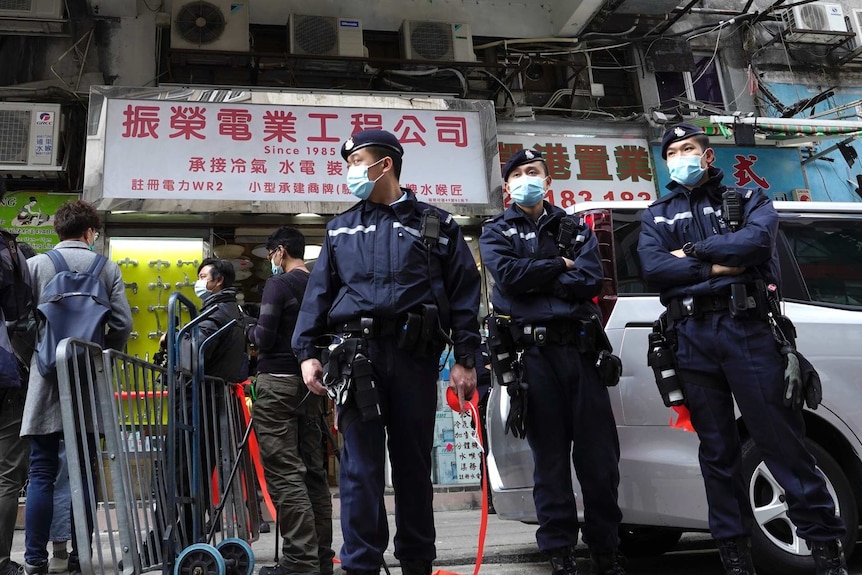 Police officers stand guard outside office of District councillor and lawyer Daniel Wong Kwok-tung