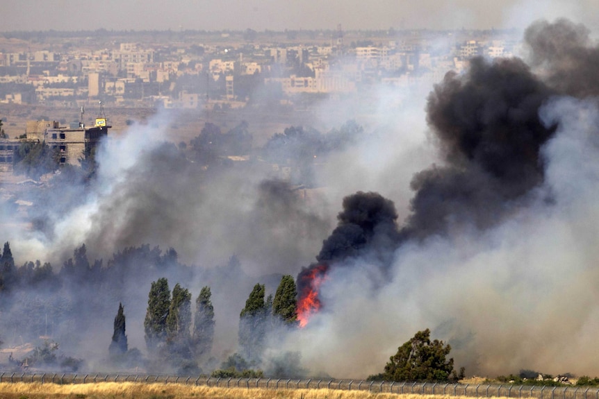 Smoke billows from Golan Heights after clash between rebel and Syrian forces