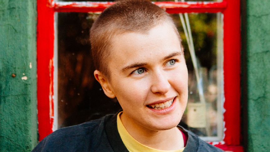 Image: Close up of Alex The Astronaut, wearing dark blue t-shirt,  with shaved head