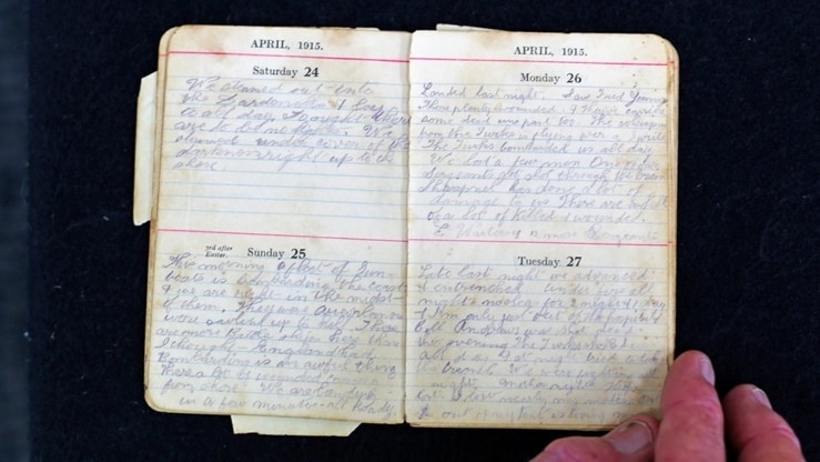 A diary from April 1915 open with handwriting across it.