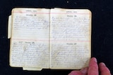 A diary from April 1915 open with handwriting across it.