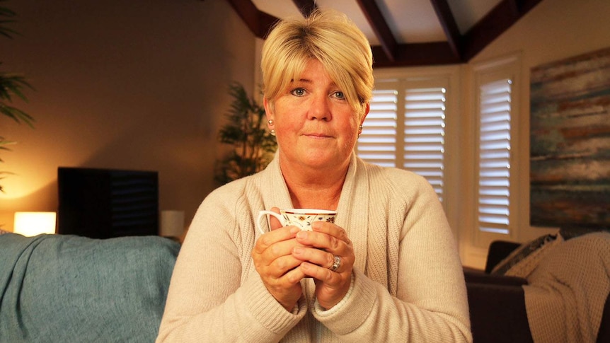 Terminal cancer sufferer Tanya Battel, holds a cup of tea in her bedroom of her Brisbane home.