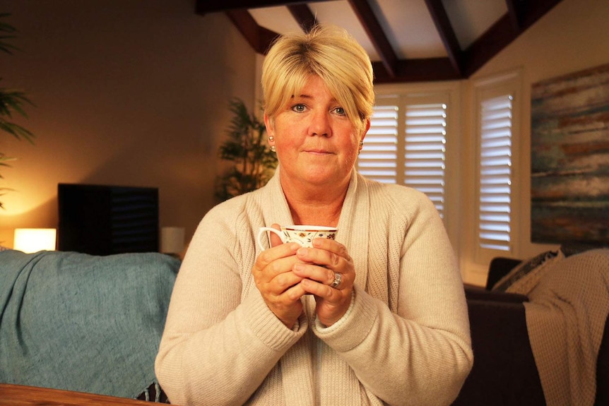 Terminal cancer sufferer Tanya Battel, holds a cup of tea in her bedroom of her Brisbane home.