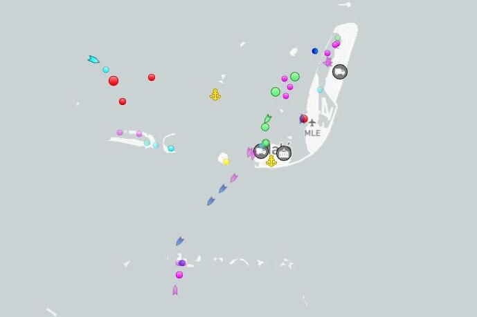 A grey map shows coloured dots denoting boats in the ocean