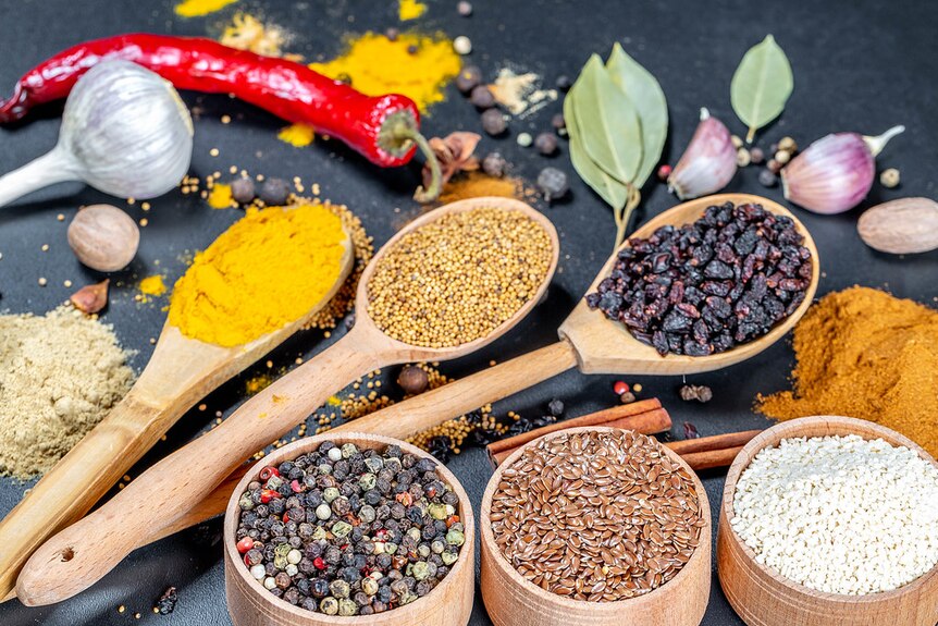 A selection of colourful spices on a dark background