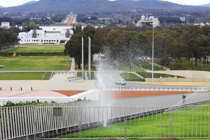 Sprinklers in action at Parliament House.