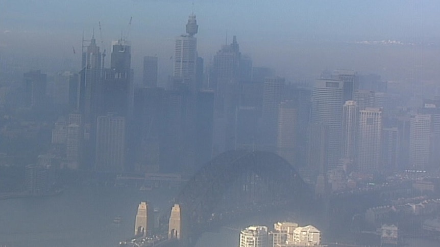 The Sydney Harbour Bridge and CBD covered in a thick hazy smoke.