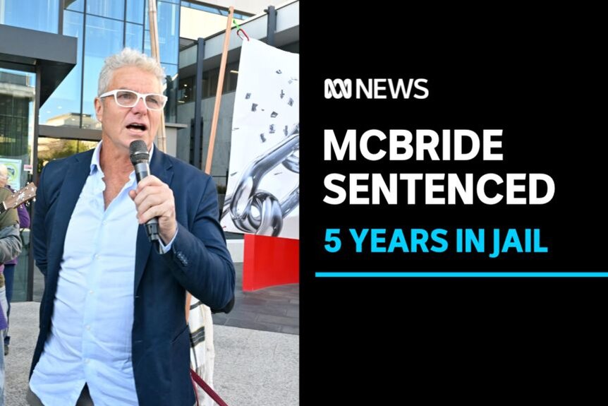 McBride Sentenced, 5 Years in Jail: A man speaks into a microphone outside a courthouse. A man plays a guitar in the background.