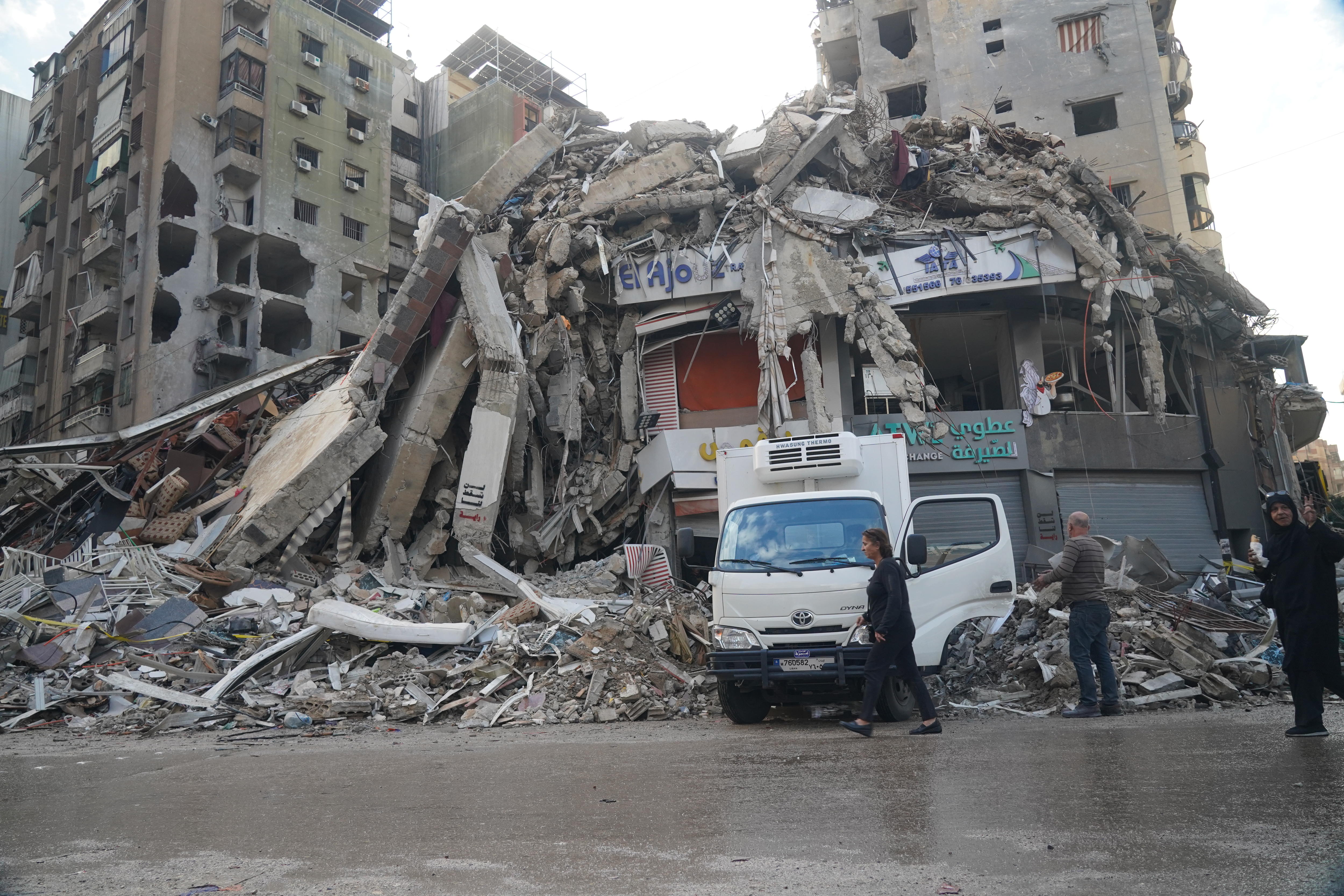 A photo of a collapsed building with debris all around its base.