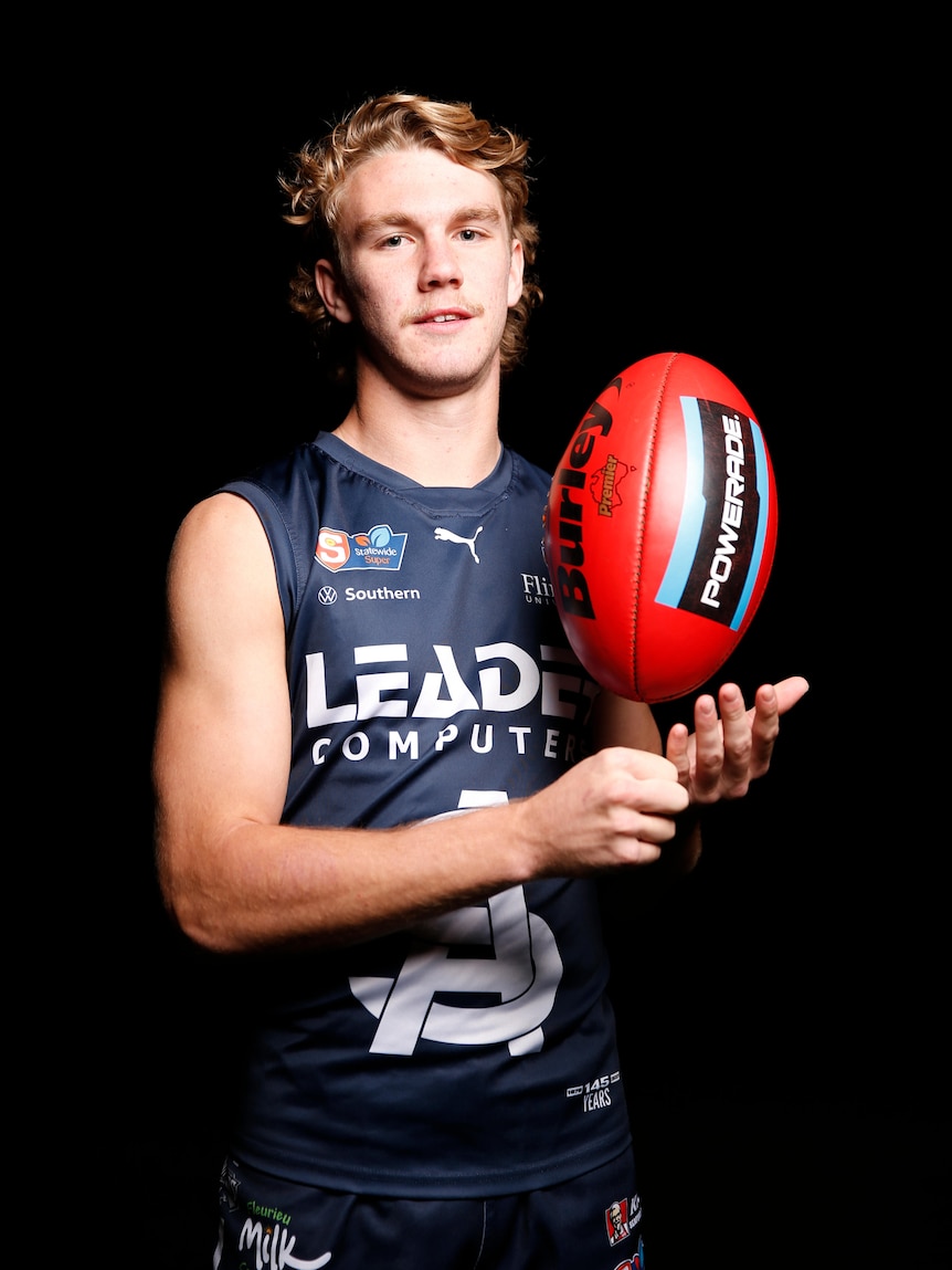 Jason Horne-Francis holds a football in a promo shot.