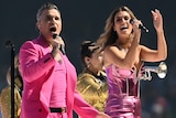 Robbie Williams and Delta Goodrem perform during the 2022 AFL grand final pre-match show.