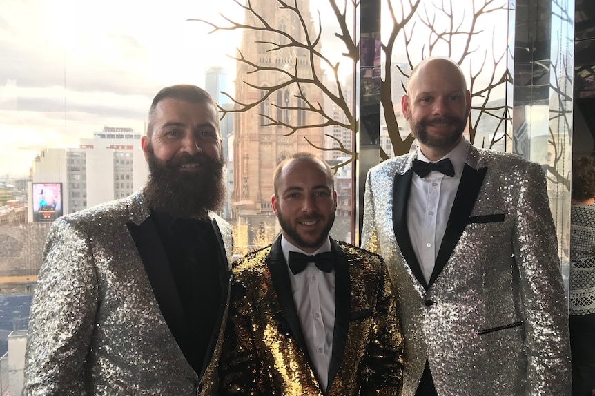 Daniel, Craig, and Jared in sparkly suits.