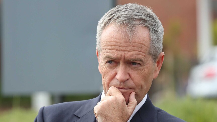 Bill Shorten looks into the distance and holds his chin