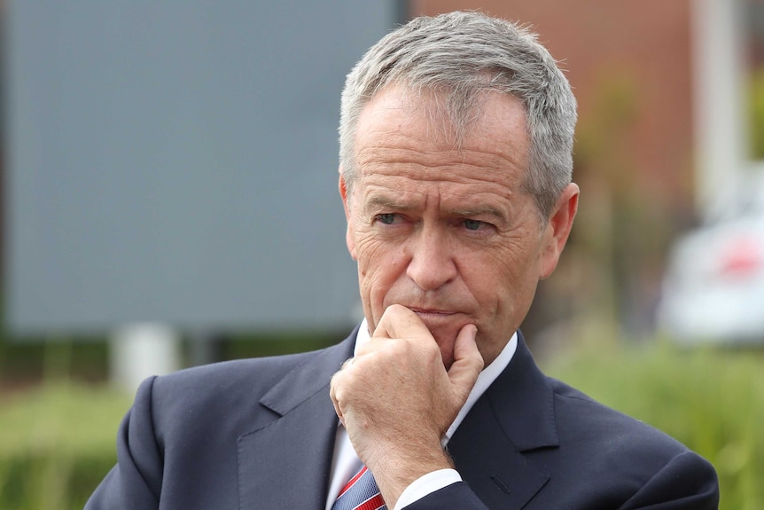 Bill Shorten looks into the distance and holds his chin