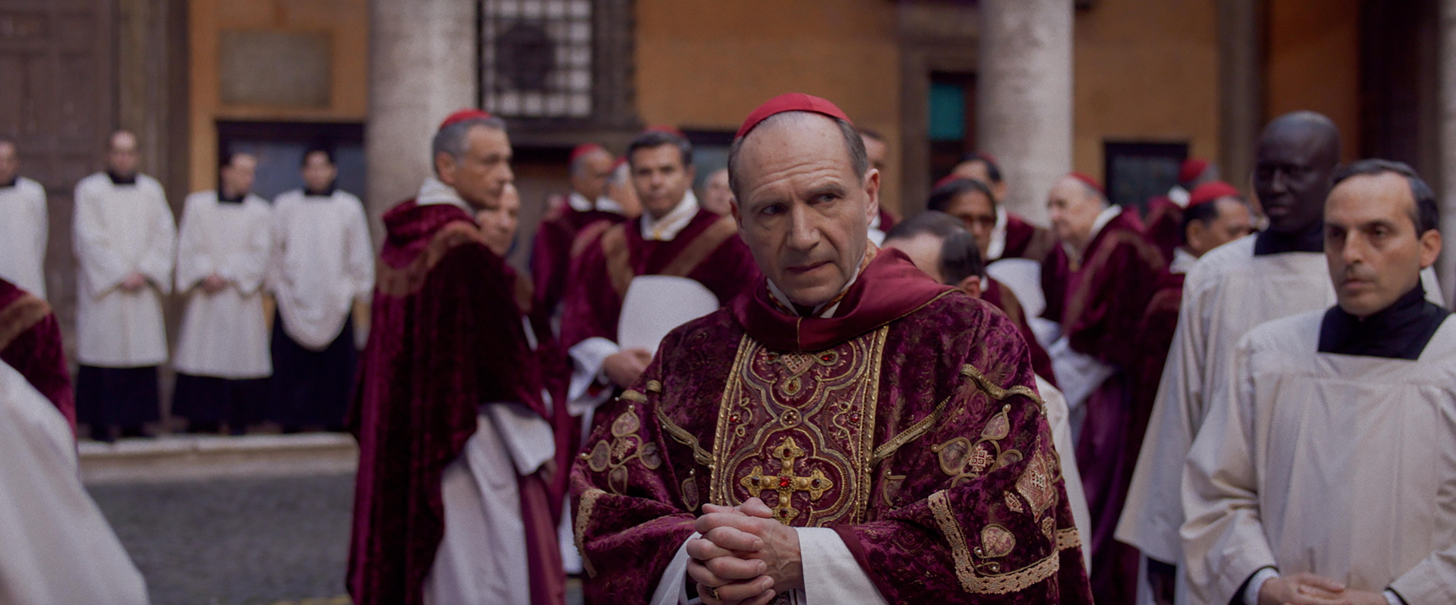 Ralph Fiennes in a Vatican courtyard in the film Conclave.