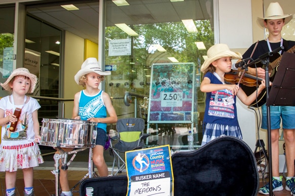 Four young children, two boys and two girls busk on the streets of Tamworth