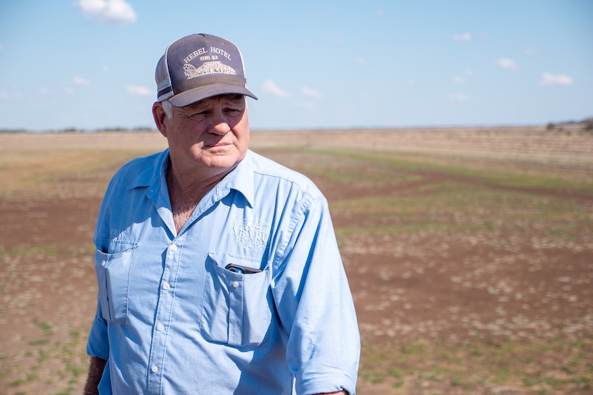 Frank Deshon stands near an empty dam on his property near Hebel in south west Queensland, August 2023.