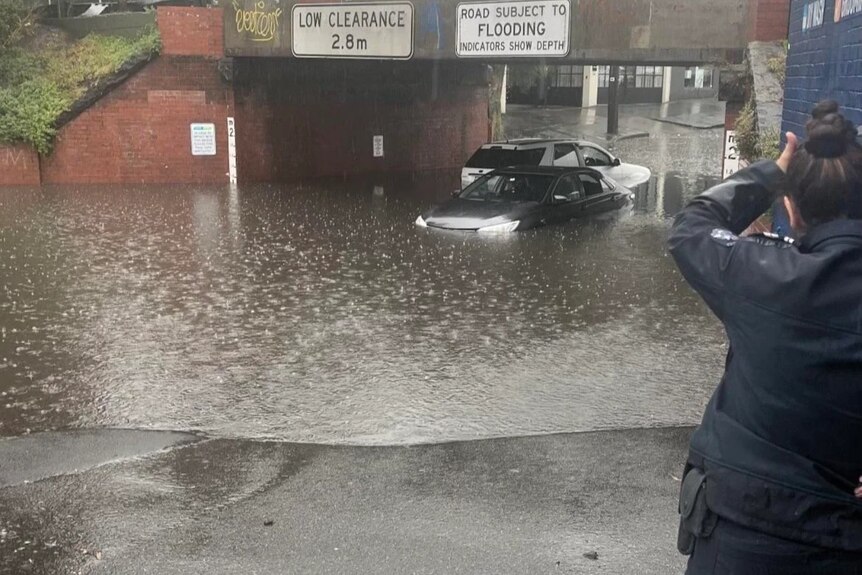 A car trapped in floodwaters under the York Street Bridge.