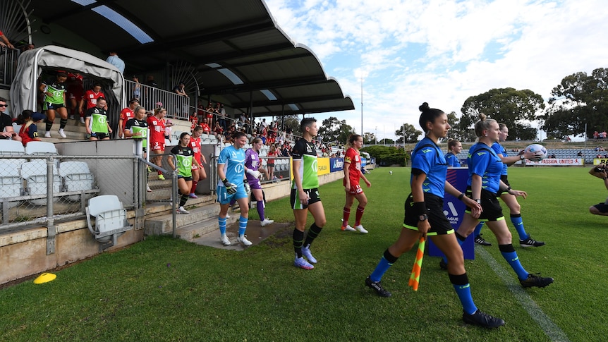 A-League Women footballers walk onto the field