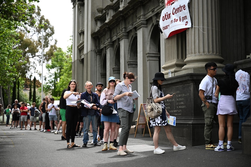 People line up at the Collingwood Town Hall voting centre in Melbourne.