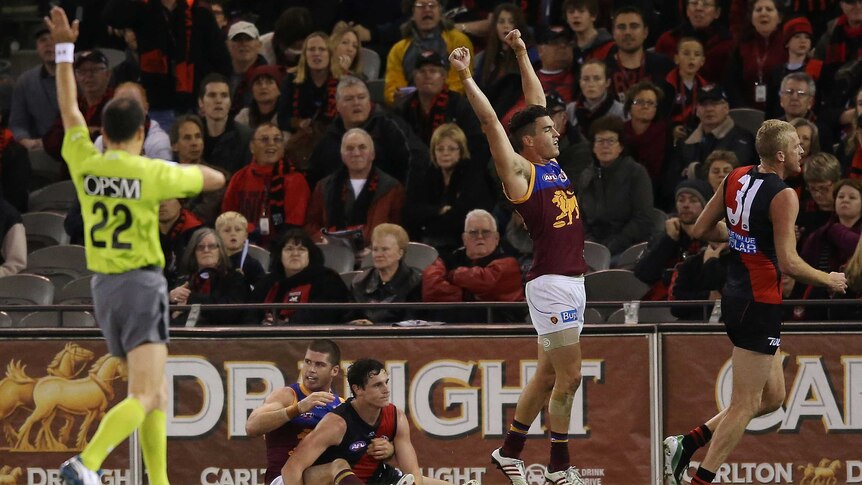 Brisbane's Tom Rockliff celebrates on the final siren as the Lions beat Essendon at Docklands.