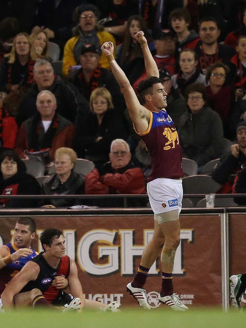 Brisbane's Tom Rockliff celebrates on the final siren as the Lions beat Essendon at Docklands.