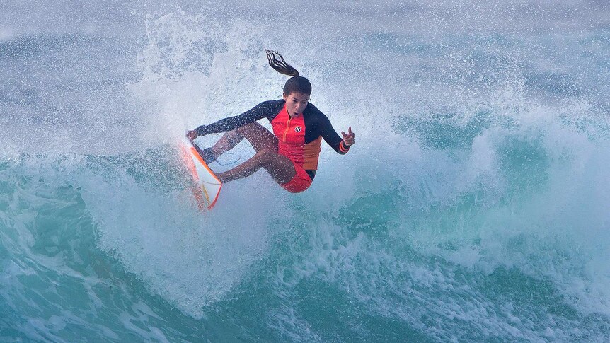 Silvana Lima surfs across the top of a wave.