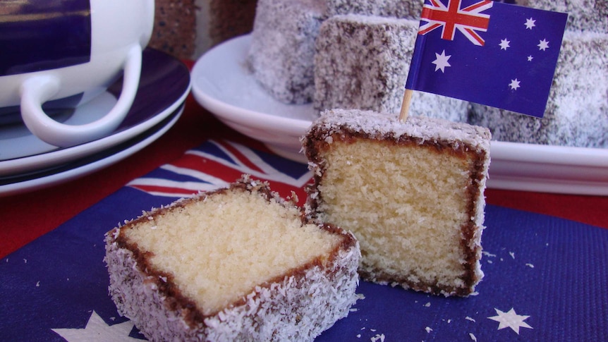 Close-up of a traditional lamington cut in half for a story about lamington's history and baking tips.