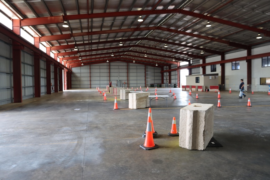 An empty warehouse with cones.